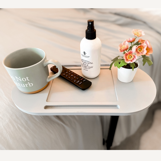 a table with a cup of coffee and a remote control on it